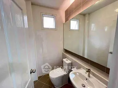 Modern bathroom with sleek fixtures and large mirror