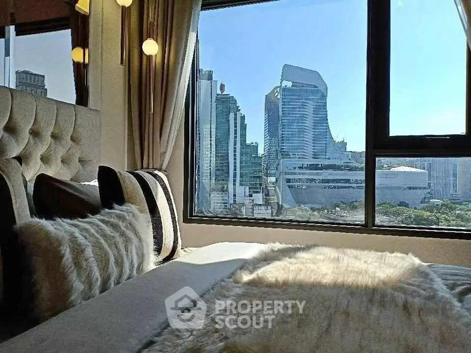 Luxurious bedroom with stunning city view from large window, featuring plush bedding and elegant decor.
