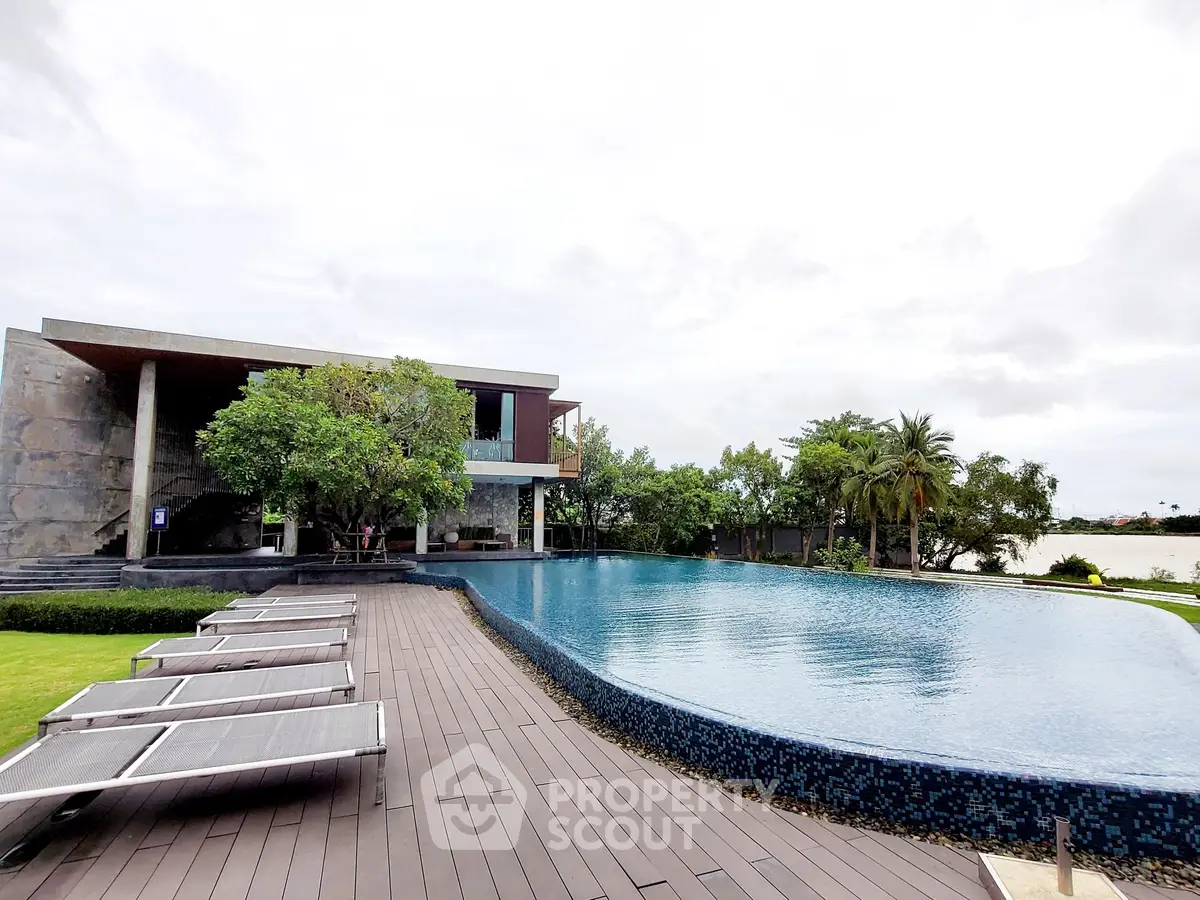 Luxurious infinity pool with modern architecture and serene lake view