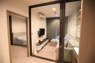 Modern apartment interior with cozy living room and bedroom, featuring sleek design and comfortable furnishings.