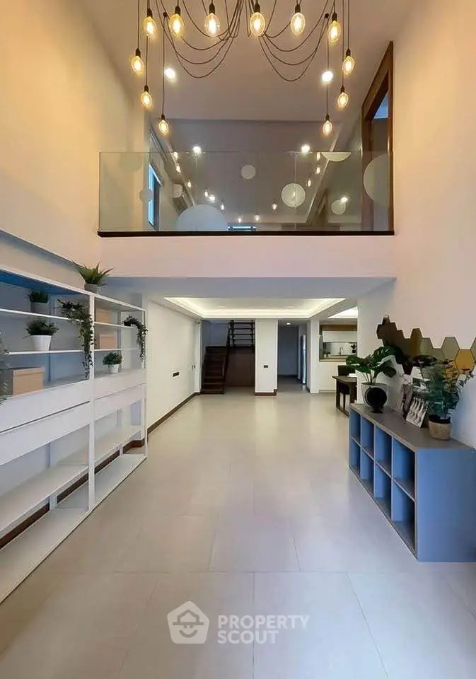 Spacious modern living room with high ceiling and elegant lighting