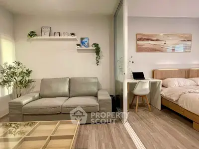 Modern studio apartment with cozy living area and stylish bedroom