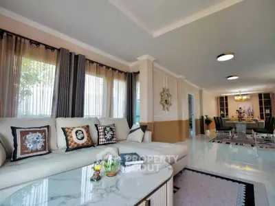 Spacious living room with elegant decor and dining area, perfect for family gatherings.