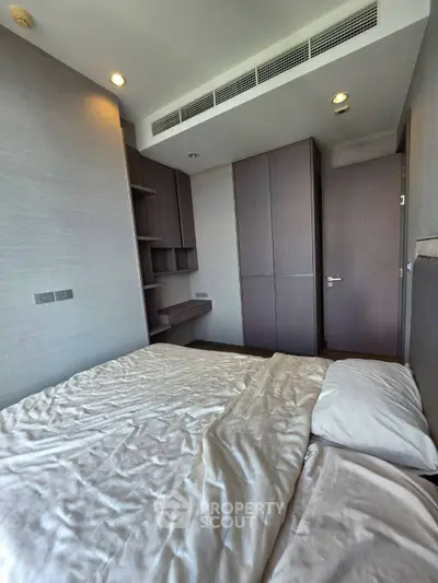 Modern bedroom with built-in wardrobe and cozy lighting