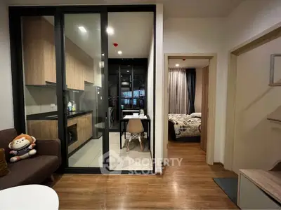 Modern apartment interior with open kitchen and cozy bedroom view.