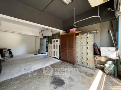 Spacious garage with ample storage and natural light, ideal for parking and organizing tools.