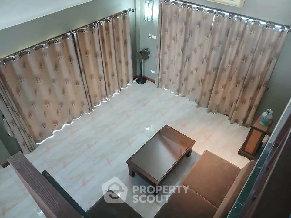 Spacious living room with elegant curtains and modern furniture