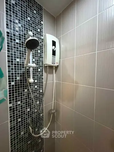 Modern bathroom shower with stylish black and white tile design.