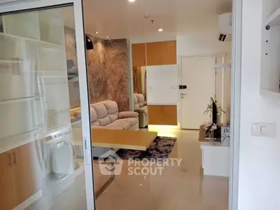 Modern living room with sliding glass door and cozy sofa in stylish apartment