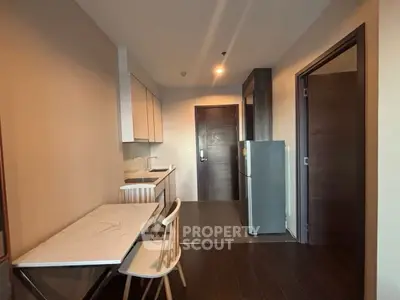 Modern kitchen with sleek design and dining area in stylish apartment