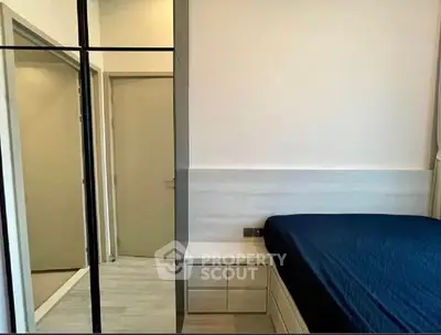 Modern bedroom with sleek design and mirrored wardrobe doors