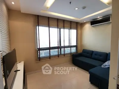 Modern living room with large windows and stylish furniture in a cozy apartment.