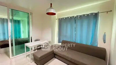 Cozy living room with modern sofa and mirrored closet in a bright apartment
