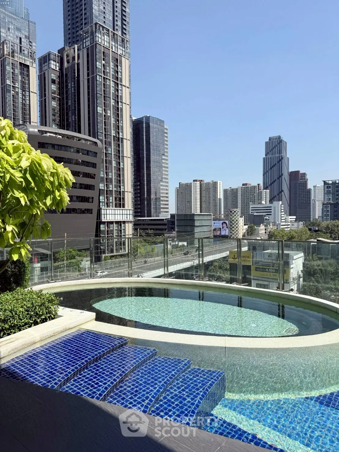 Luxurious rooftop pool with stunning city skyline views in modern urban setting.