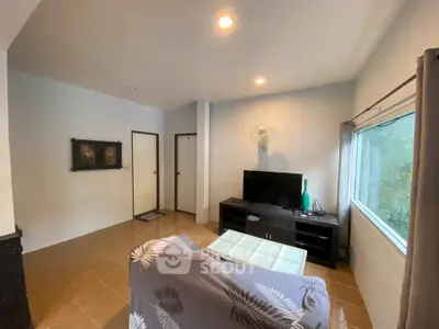 Cozy living room with modern decor and large window view