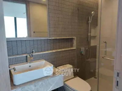 Modern bathroom with sleek fixtures and glass shower enclosure