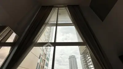 Stunning floor-to-ceiling window with cityscape view in modern apartment