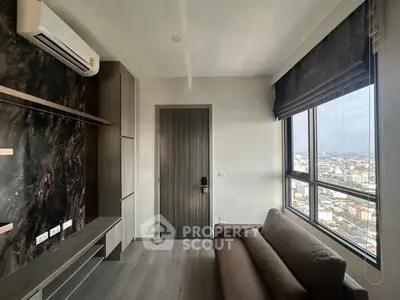 Modern living room with city view, featuring sleek design and large windows.