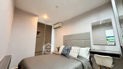 Modern bedroom with stylish decor and air conditioning in a cozy apartment.