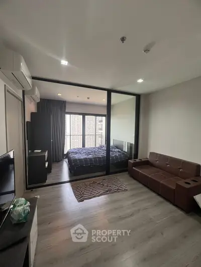 Modern studio apartment with glass partition and stylish furnishings