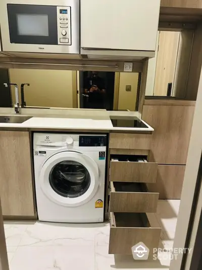 Modern kitchen with built-in microwave and washing machine