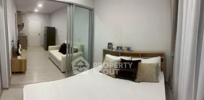 Modern studio apartment with cozy bedroom and stylish living area, perfect for urban living.