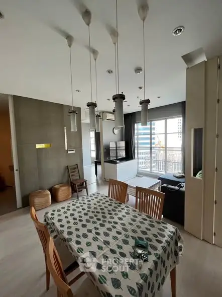 Modern dining area with stylish lighting and open layout in a contemporary apartment.