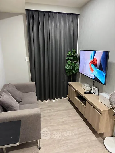 Cozy living room with modern decor and flat-screen TV, perfect for relaxation.