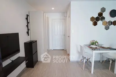 Modern living room with stylish decor and dining area in a cozy apartment.