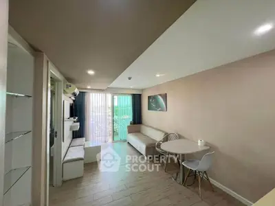 Modern living room with sleek furniture and large windows offering natural light.