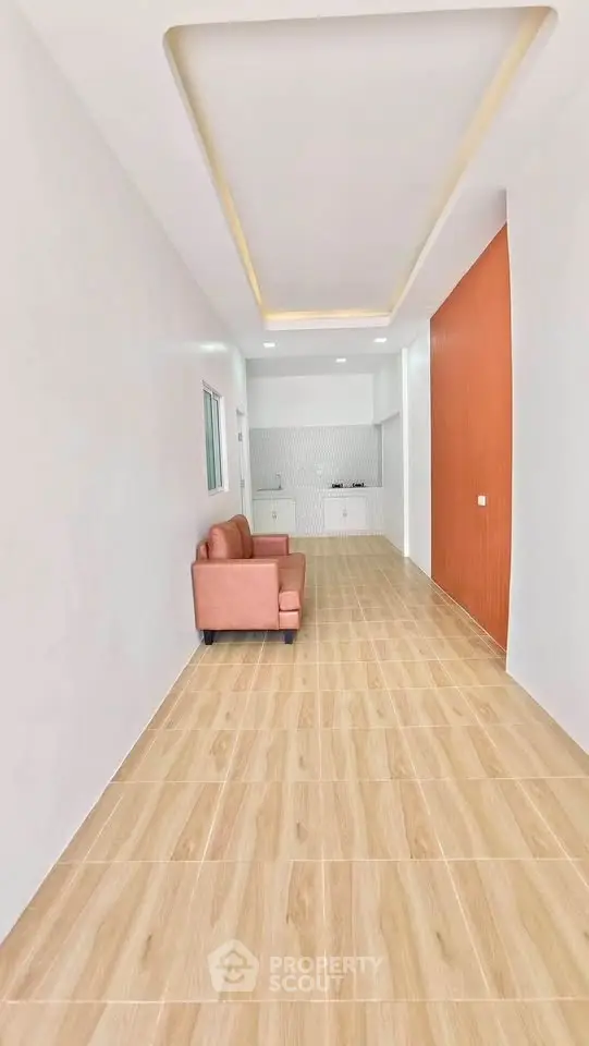 Spacious modern living room with sleek wooden flooring and stylish recessed lighting.