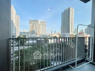 Stunning cityscape view from modern apartment balcony with sleek railing.