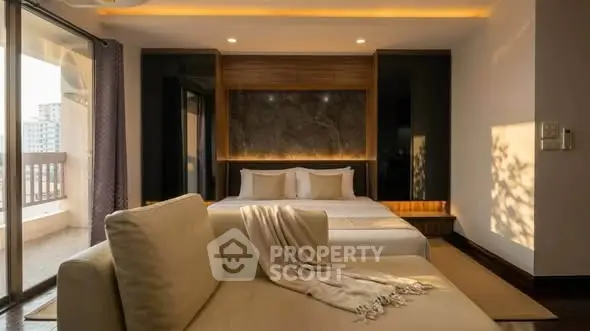 Luxurious bedroom with modern decor and balcony access in a high-rise apartment.