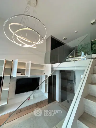 Modern living room with stylish lighting and glass staircase