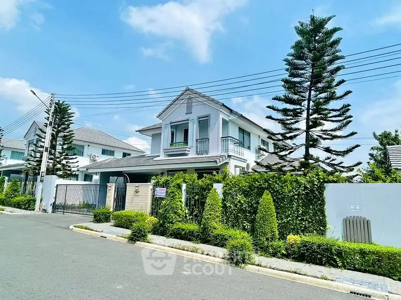 Charming two-story house with lush garden and modern design in a serene neighborhood.