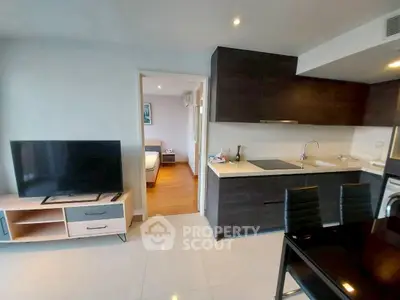 Modern open-layout kitchen and living area with sleek design and natural light