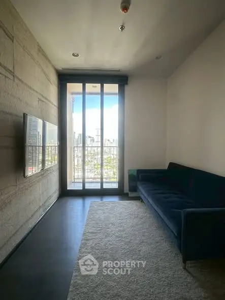 Modern living room with sleek design and city view through large windows.