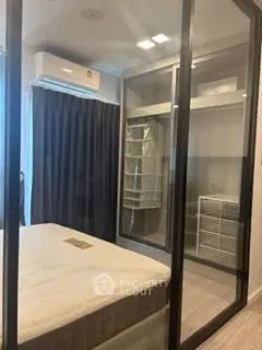 Modern bedroom with glass-enclosed walk-in closet and air conditioning