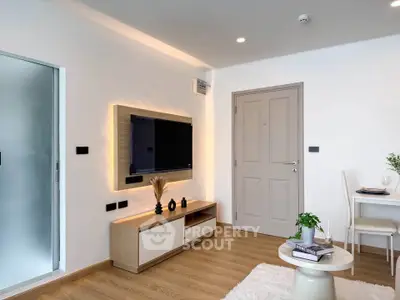 Modern living room with stylish decor and wall-mounted TV in a cozy apartment.