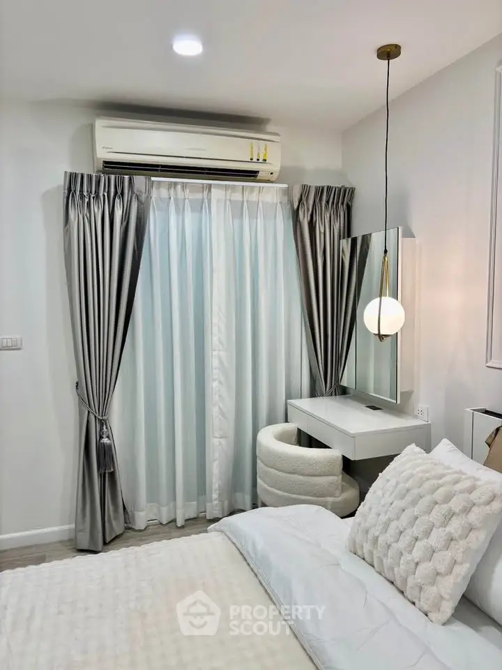 Cozy bedroom with elegant decor, featuring a stylish vanity and luxurious bedding, perfect for relaxation.