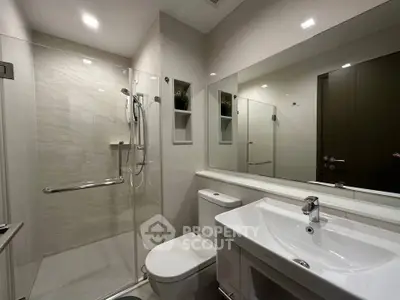 Modern bathroom with sleek fixtures and glass shower enclosure