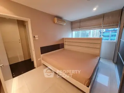 Modern bedroom with large window and air conditioning in urban apartment