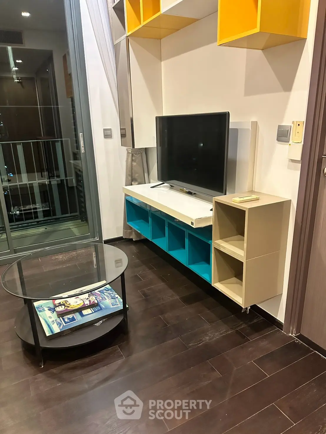 Modern living room with stylish TV stand and glass coffee table