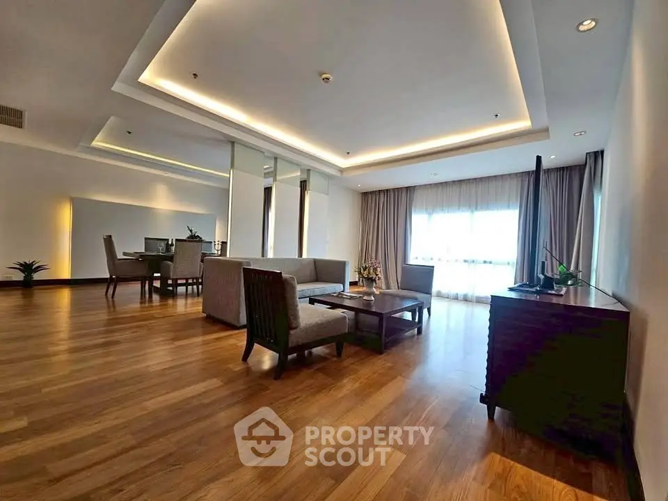Spacious modern living room with elegant wooden flooring and stylish furniture