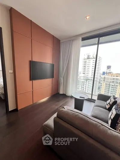 Modern living room with city view, featuring sleek sofa and wall-mounted TV in a high-rise apartment.