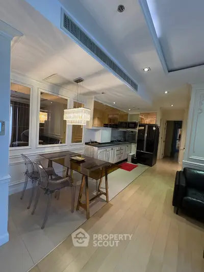 Modern open-layout kitchen with elegant dining area and stylish lighting