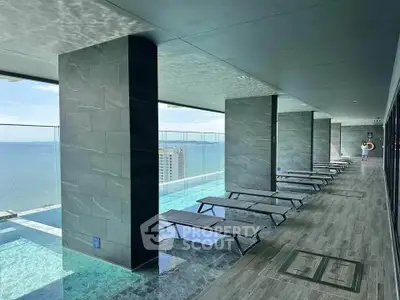 Luxurious rooftop pool with stunning ocean view and modern lounge chairs