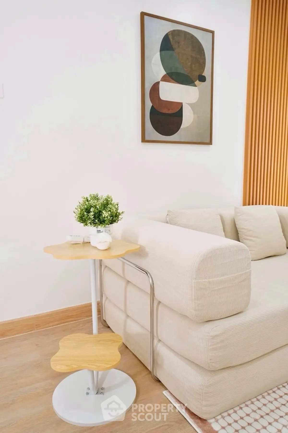 Modern living room with stylish sofa and abstract art on wall