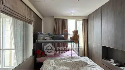 Cozy bedroom with bunk bed and large windows in modern apartment
