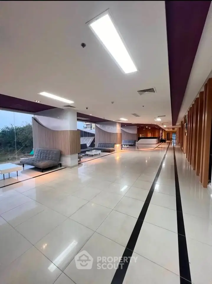 Spacious modern lobby with sleek design and ample seating in a contemporary building.